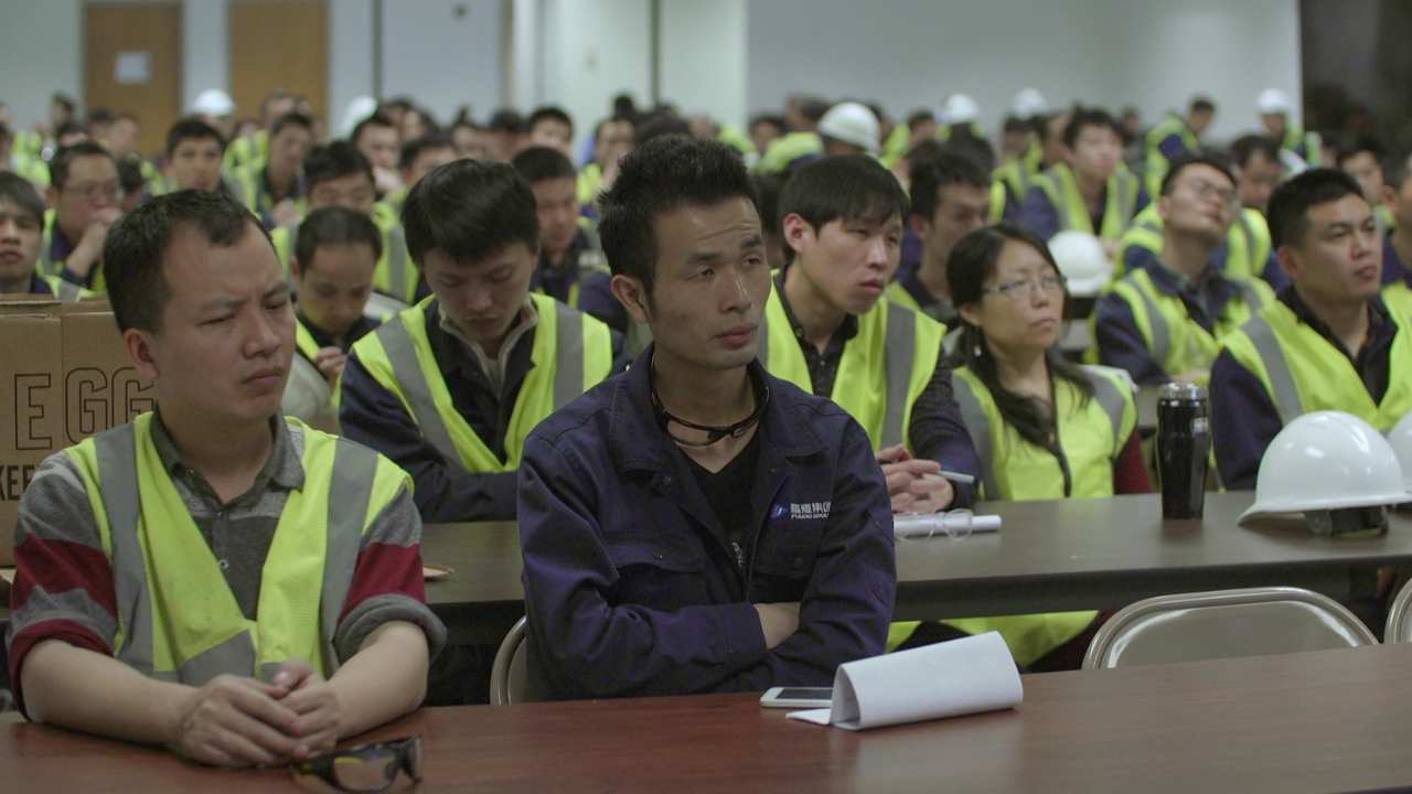 a group of people in safety vests sitting together